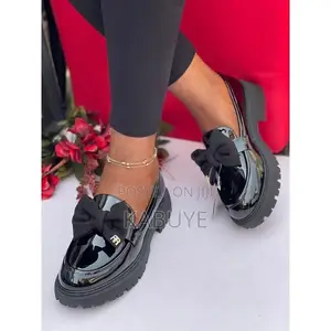 Stylish Black Patent Chunky Loafers Featuring a Prominent Bow.