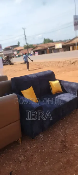 A Two Seater Sofa Set With Yellow Pillows