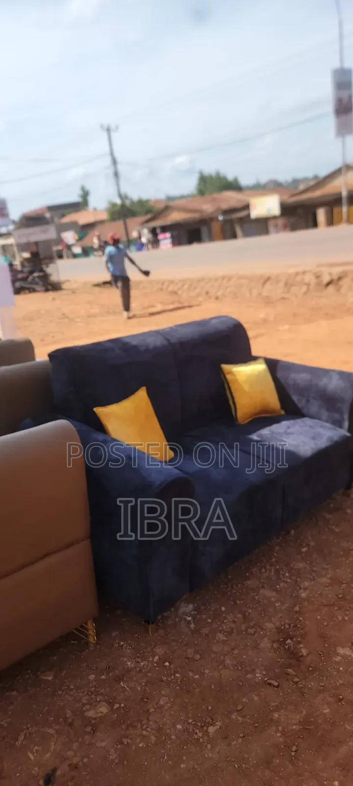 A Two Seater Sofa Set With Yellow Pillows
