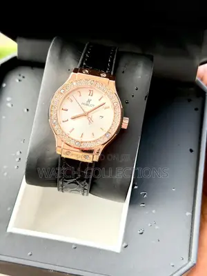 Black Ladys Watch With a Gold Head