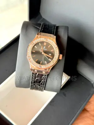 Black Ladys Watch With a Gold Head