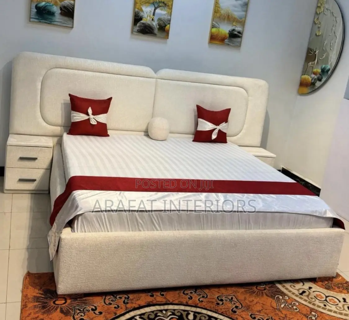 White Upholstered Bed With Red Accents Creates
