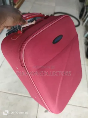 Japan Used Red, Soft-Sided Trolley Suitcase With a Telescopic Handle.