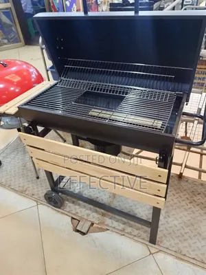 Metal Trolley Charcoal Barbecue Grill With a Wooden Shelf.