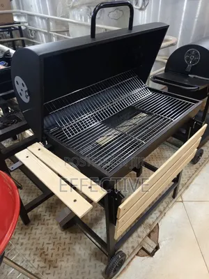 Metal Trolley Charcoal Barbecue Grill With a Wooden Shelf.