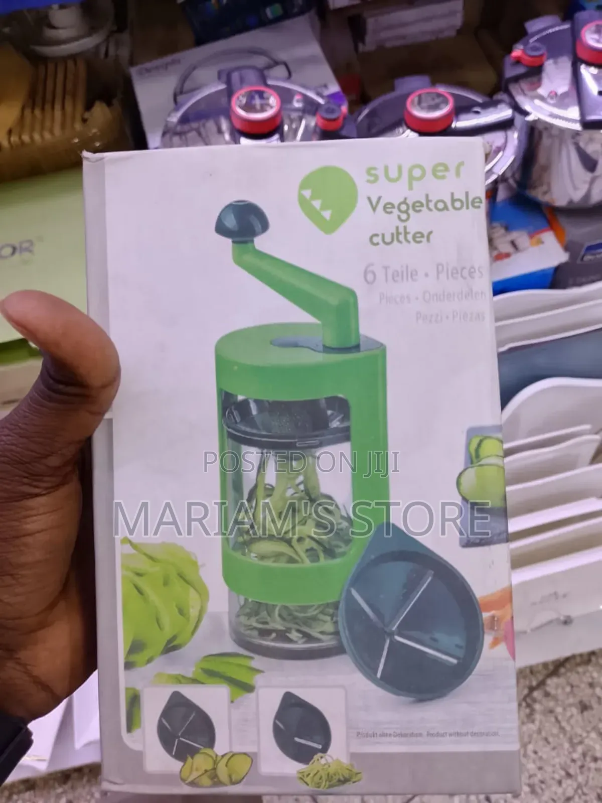 6-Piece Spiral Slicer With a Manual Hand Crank and Green Plastic Body.