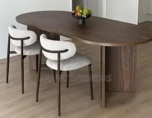 The Oval Walnut Table Paired With These Sculptural Bouclé Chairs