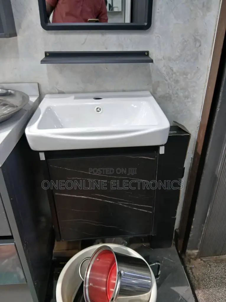 Sleek Black Vanity Set Ft a White Ceramic Basin Sink and a Marbl
