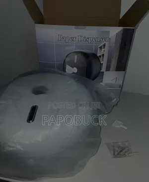 Wall-Mounted Plastic Paper Dispenser Likely for Commercial Use