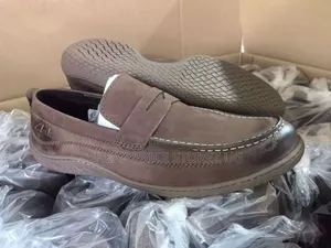 These Appear To Be Brown Clarks Leather Loafers, Featuring A Classic