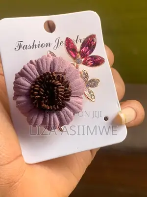 Pink Suede-Like Fabric Flower Brooch Features a Dark a Brown Center.