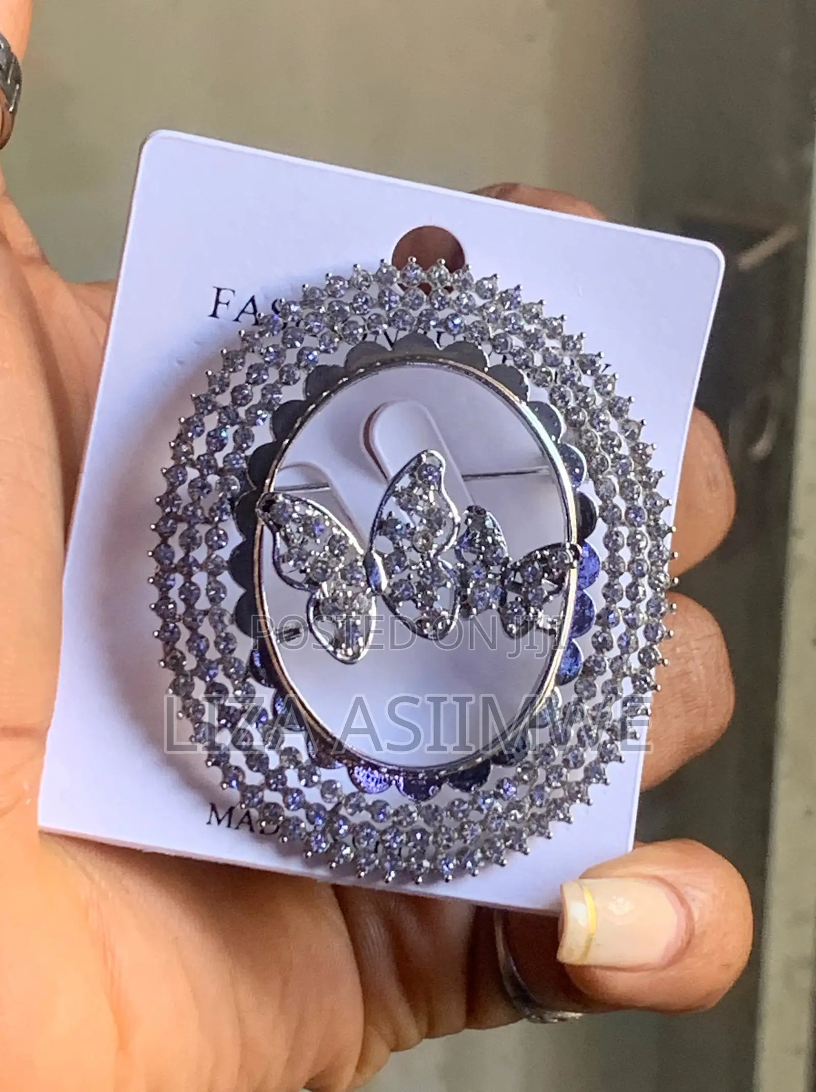 Butterfly Brooch With a Circular Frame Adorned With Rhinestones
