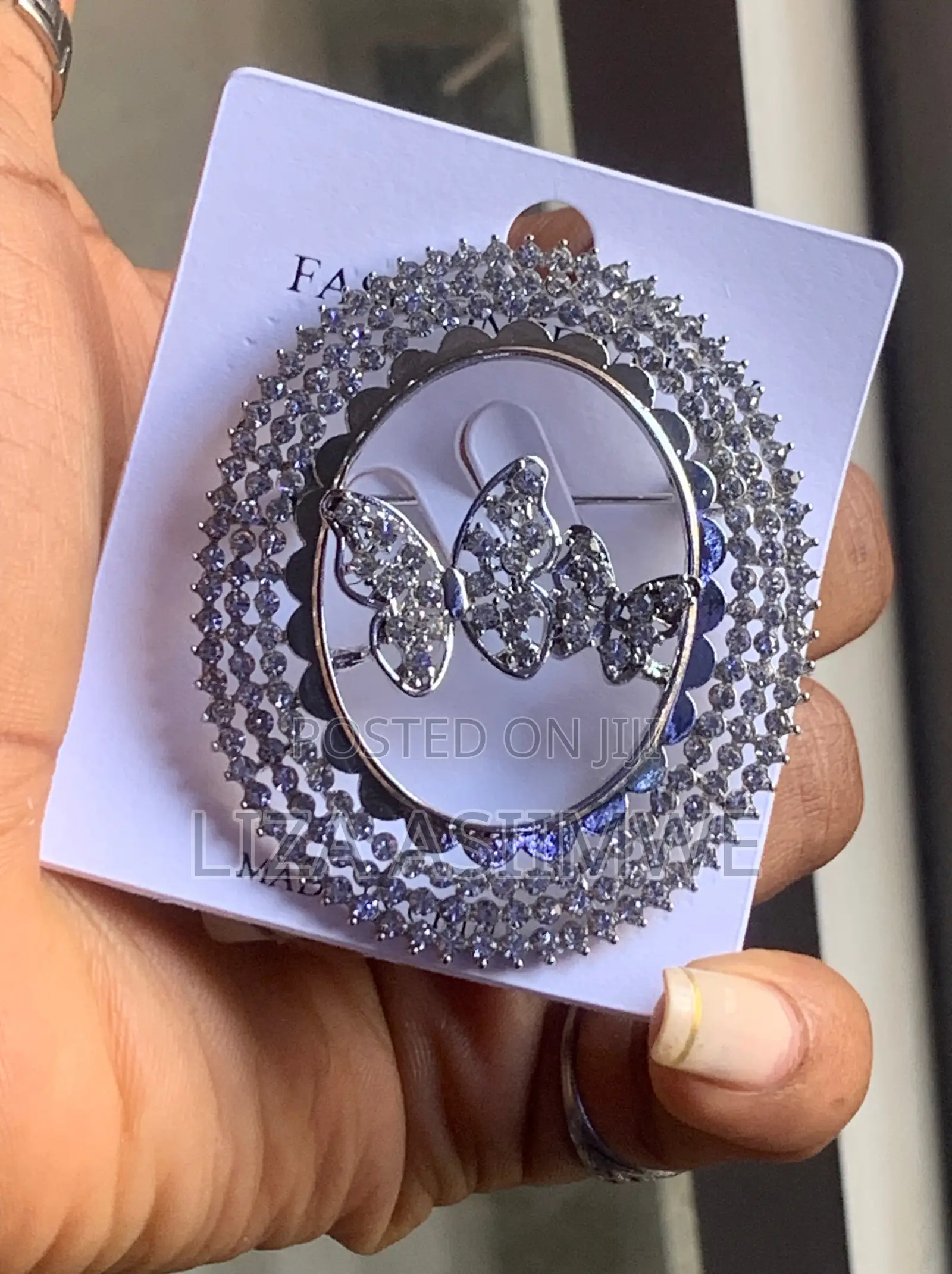 Butterfly Brooch With a Circular Frame Adorned With Rhinestones