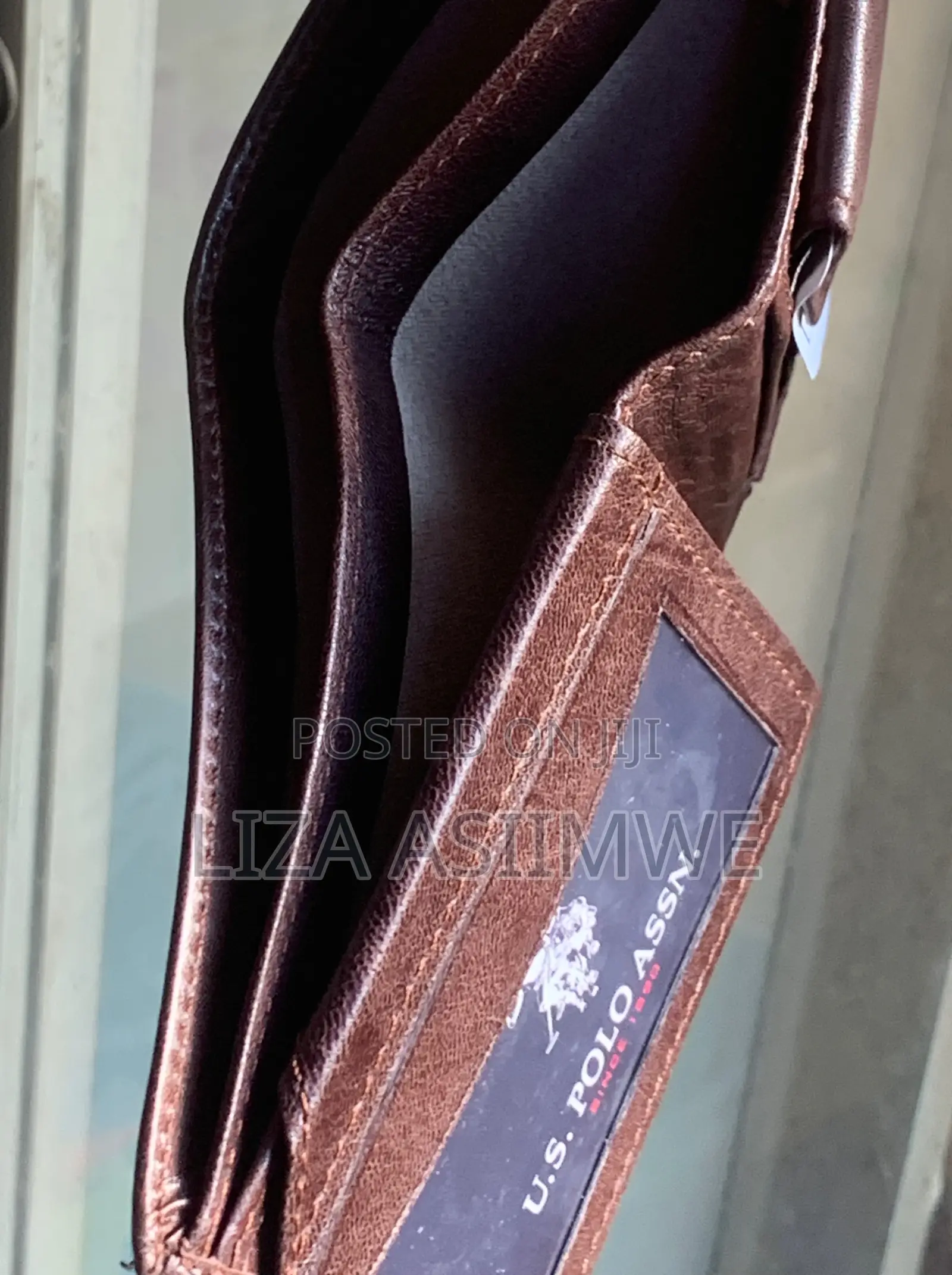 Brown Leather Bifold Wallet Features an Embossed U.S. Polo. (Uspa)