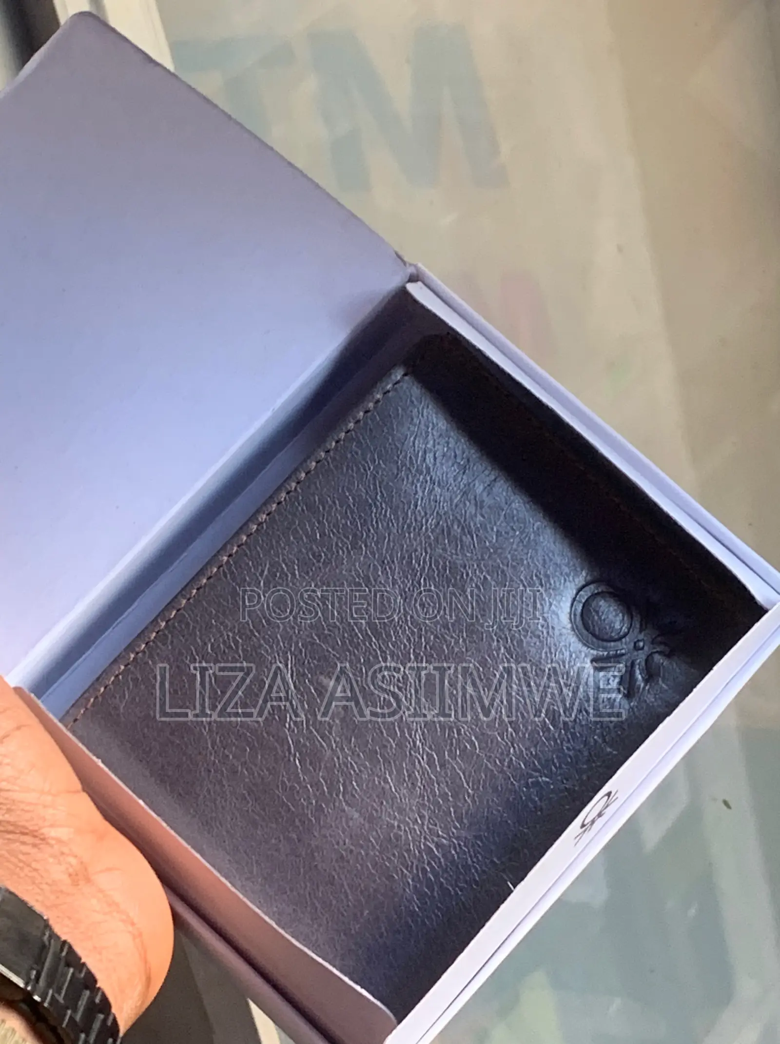 Leather Wallet Features A Textured Finish And An Embossed Logo