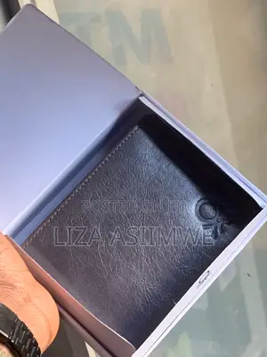 Leather Wallet Features A Textured Finish And An Embossed Logo