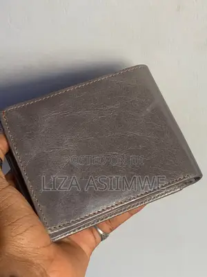 Leather Wallet Features A Textured Finish And An Embossed Logo