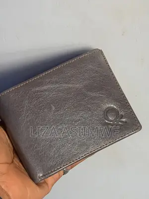 Leather Wallet Features A Textured Finish And An Embossed Logo