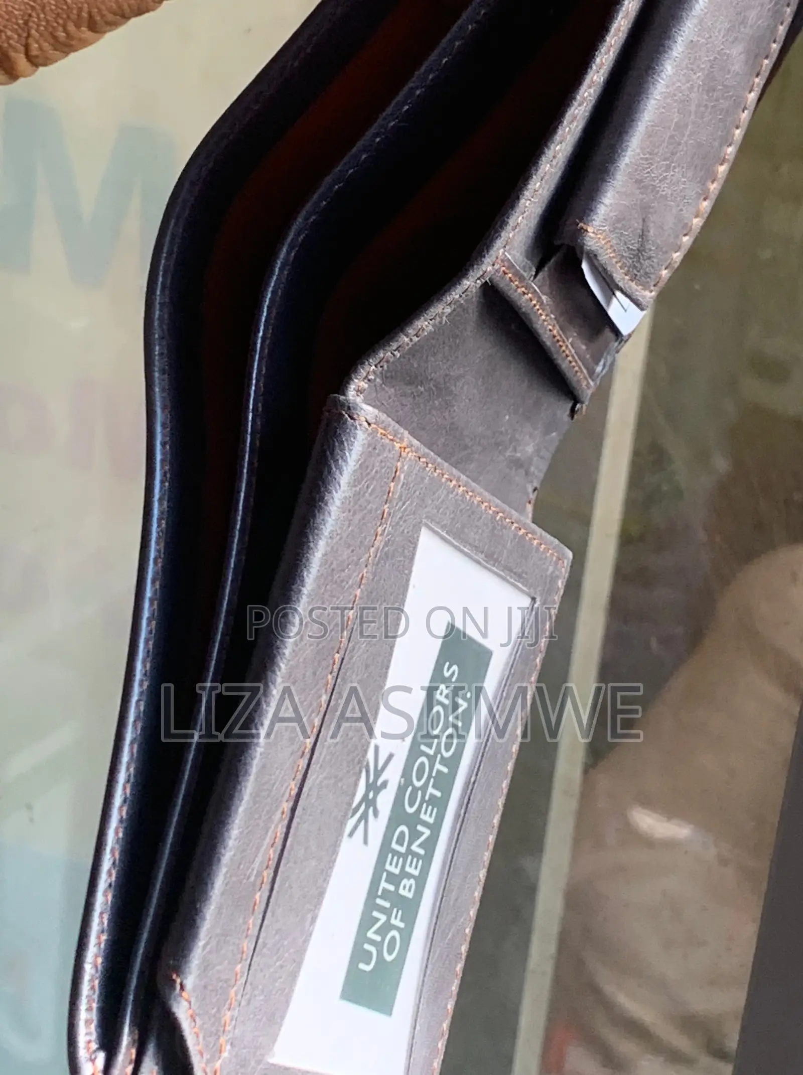 Leather Wallet Features A Textured Finish And An Embossed Logo
