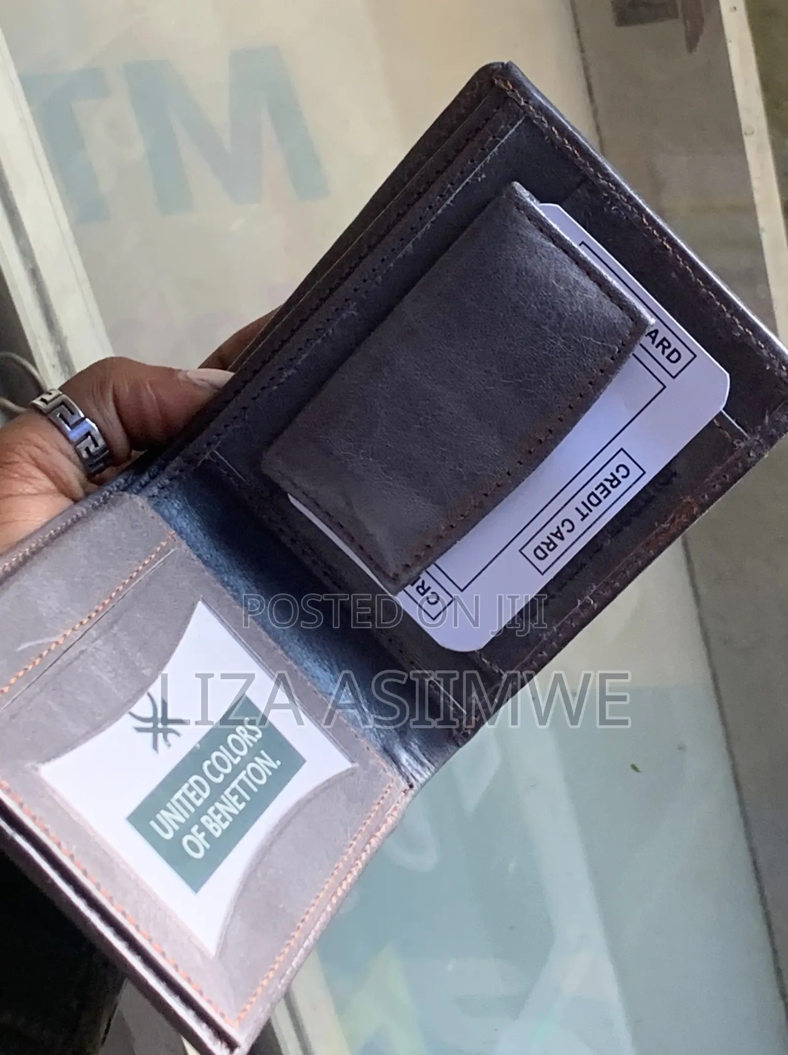 Leather Wallet Features A Textured Finish And An Embossed Logo