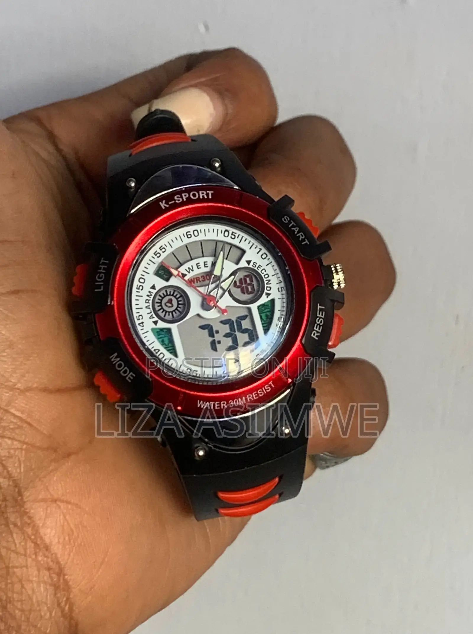 Kids Sports Watch With A Durable Black Strap And A Vibrant Red Bezel