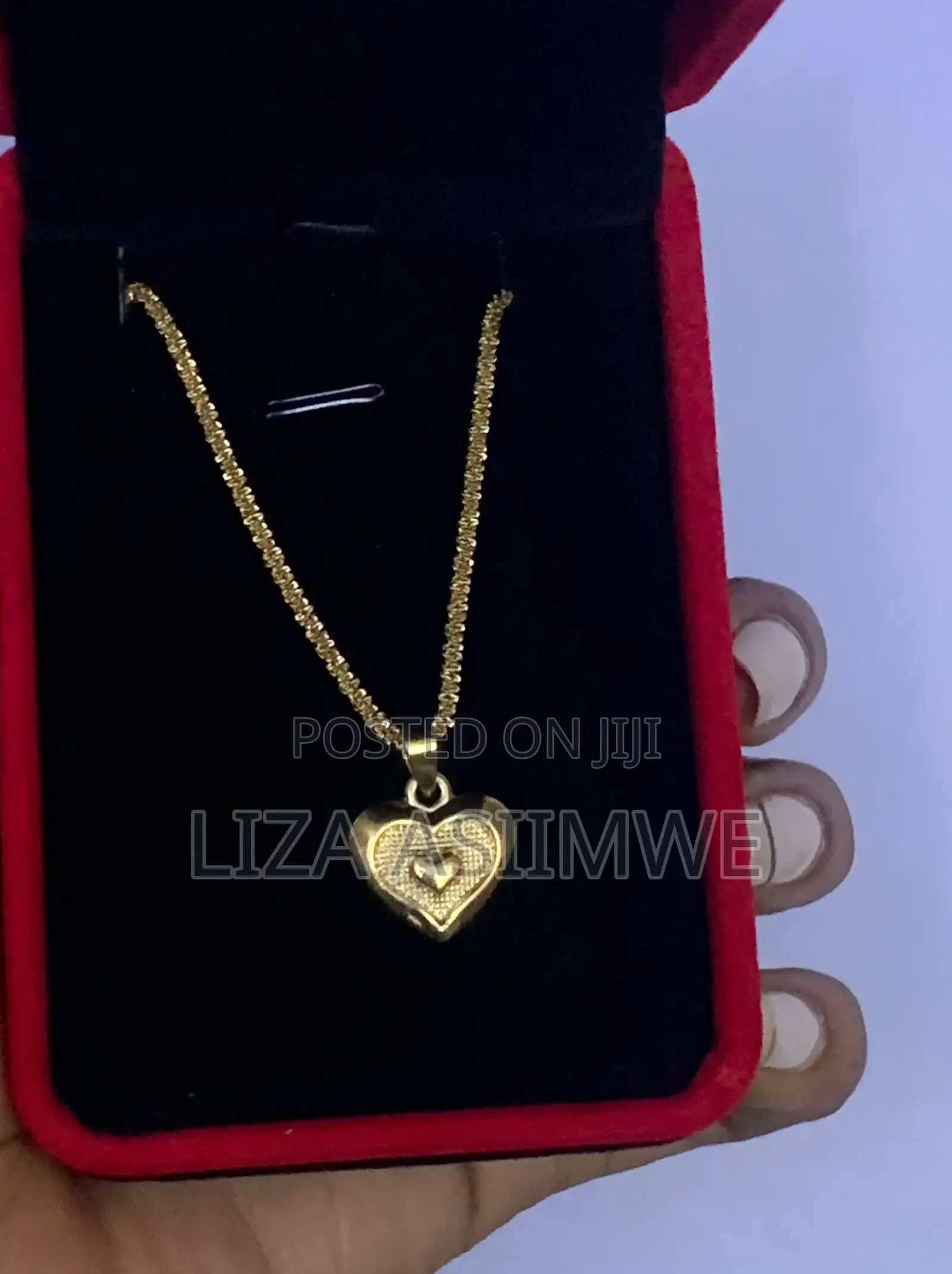 Lady’S Necklace With a Heart Shaped Pendant Inside a Larger Heart