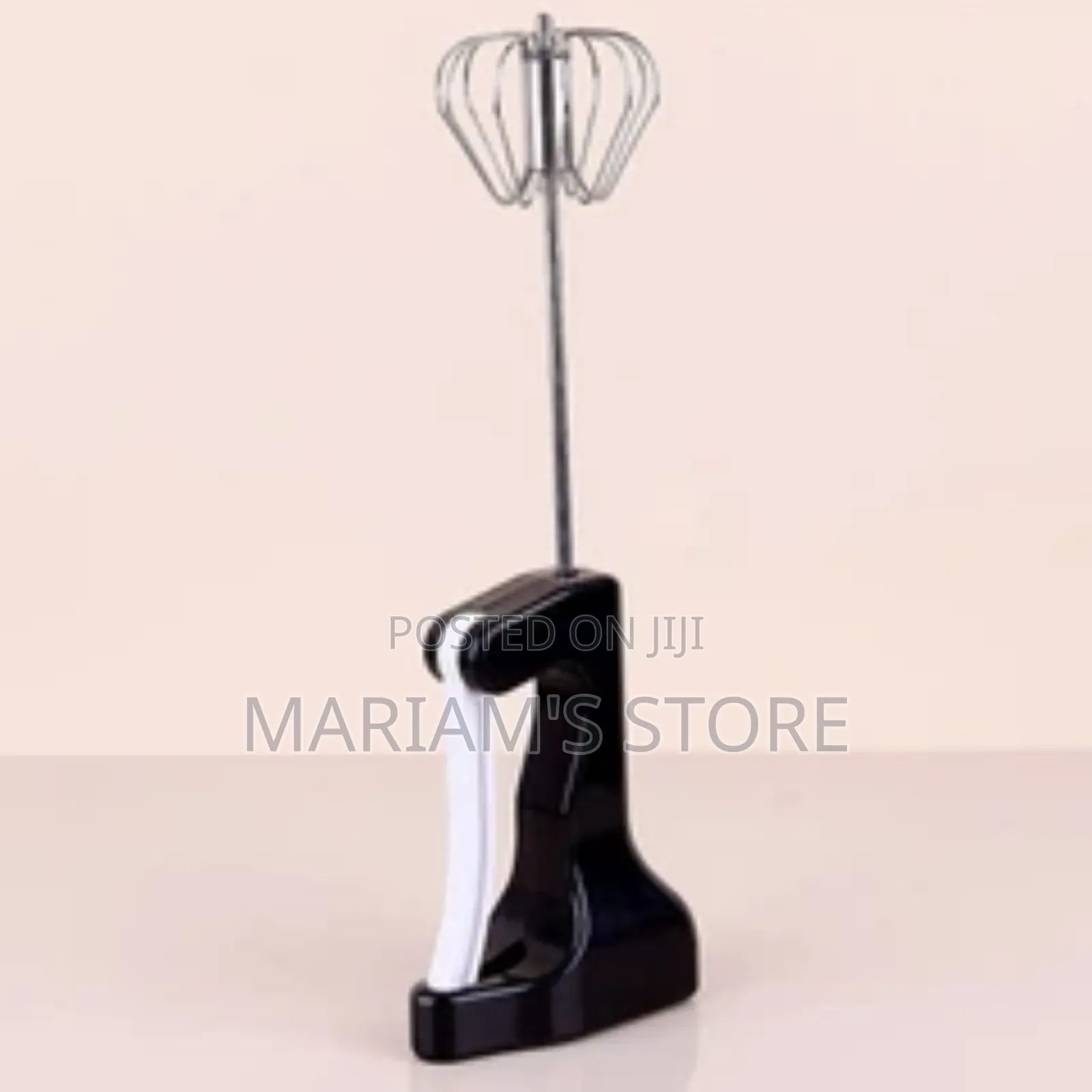 Semi-Automatic Kitchen Whisk With a Black Handle.