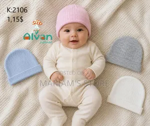 A Soft, Cream-Colored Ribbed Baby Romper With Matching Cap