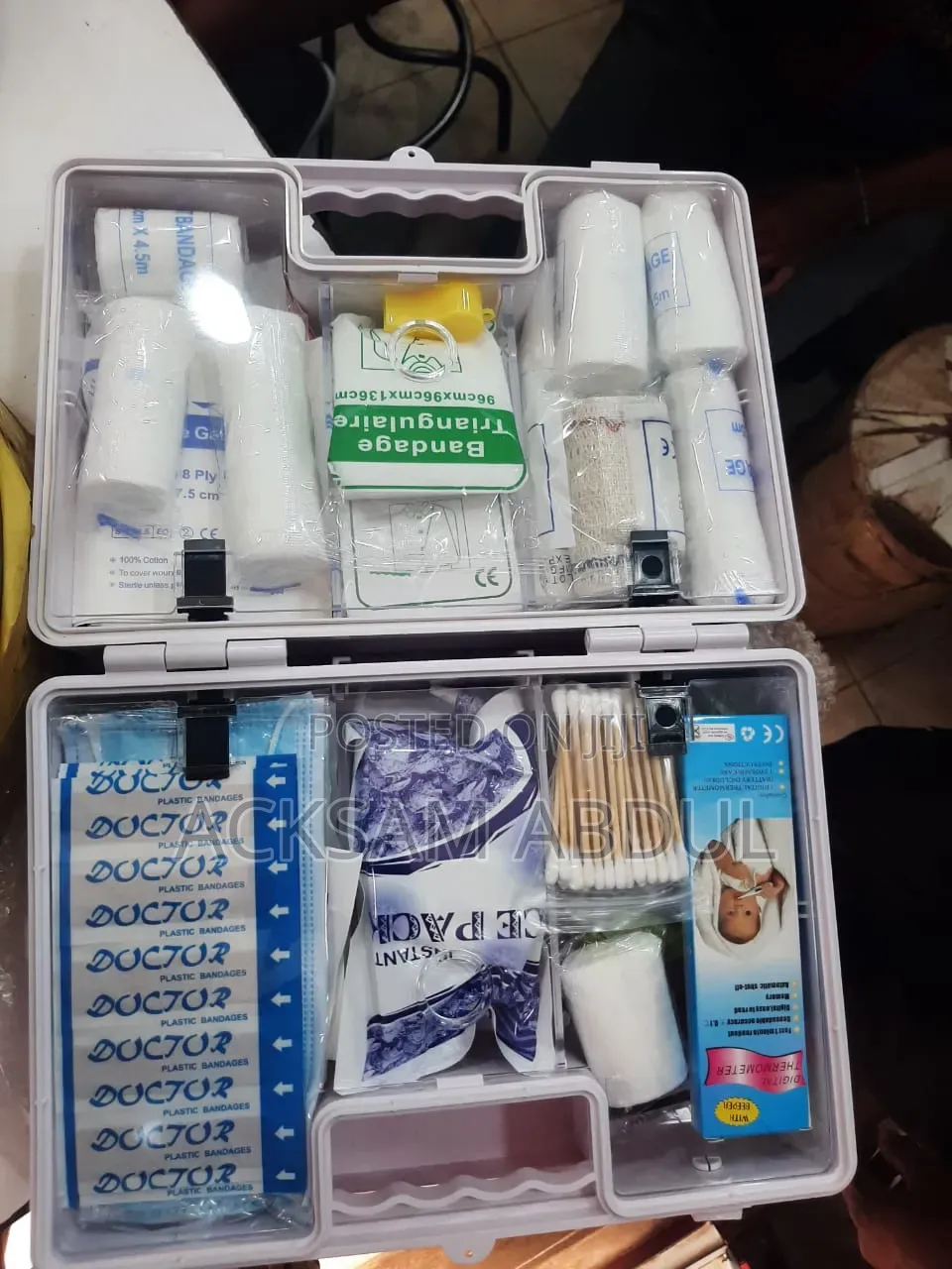 White Plastic First Aid Kit Filled With Various Medical Supplies