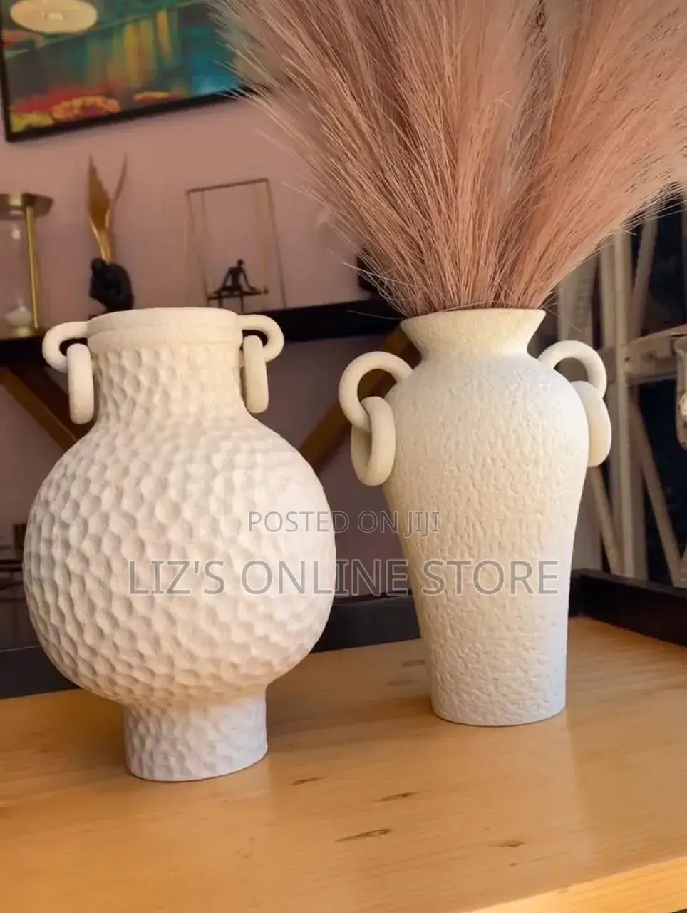 White Ceramic Vases Feature a Textured Finish and Distinctive Handles
