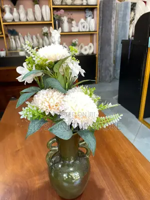 Blossoms Housed in a Sleek Olive Green Ceramic Vase
