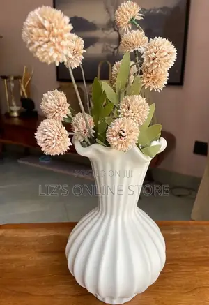 White, Ribbed Flower Vase Features a Flared, Shell-Patterned Top