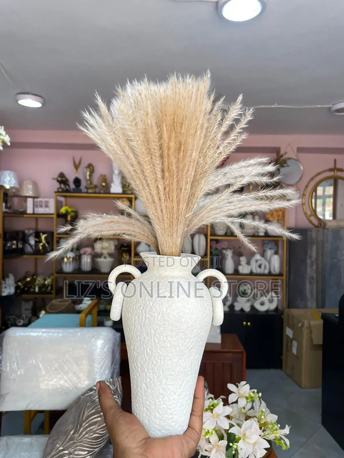 White Ceramic Vase From Awnr Features a Textured Surface.