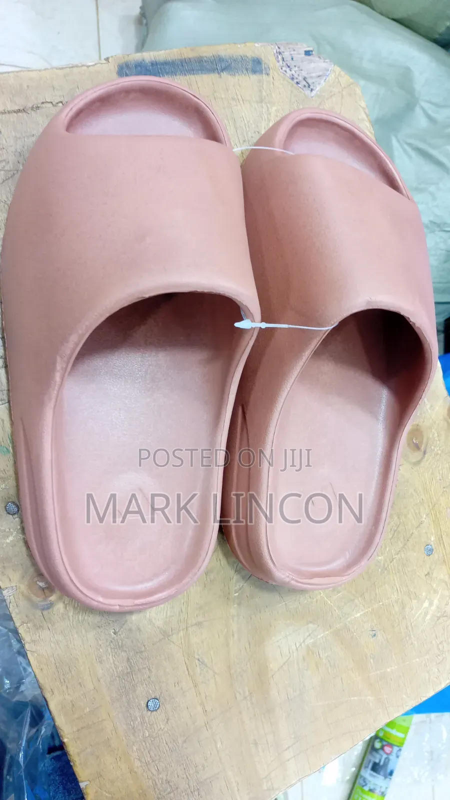 Adidas Yeezy Slides in a Dusty Rose or Ochre Colorway.
