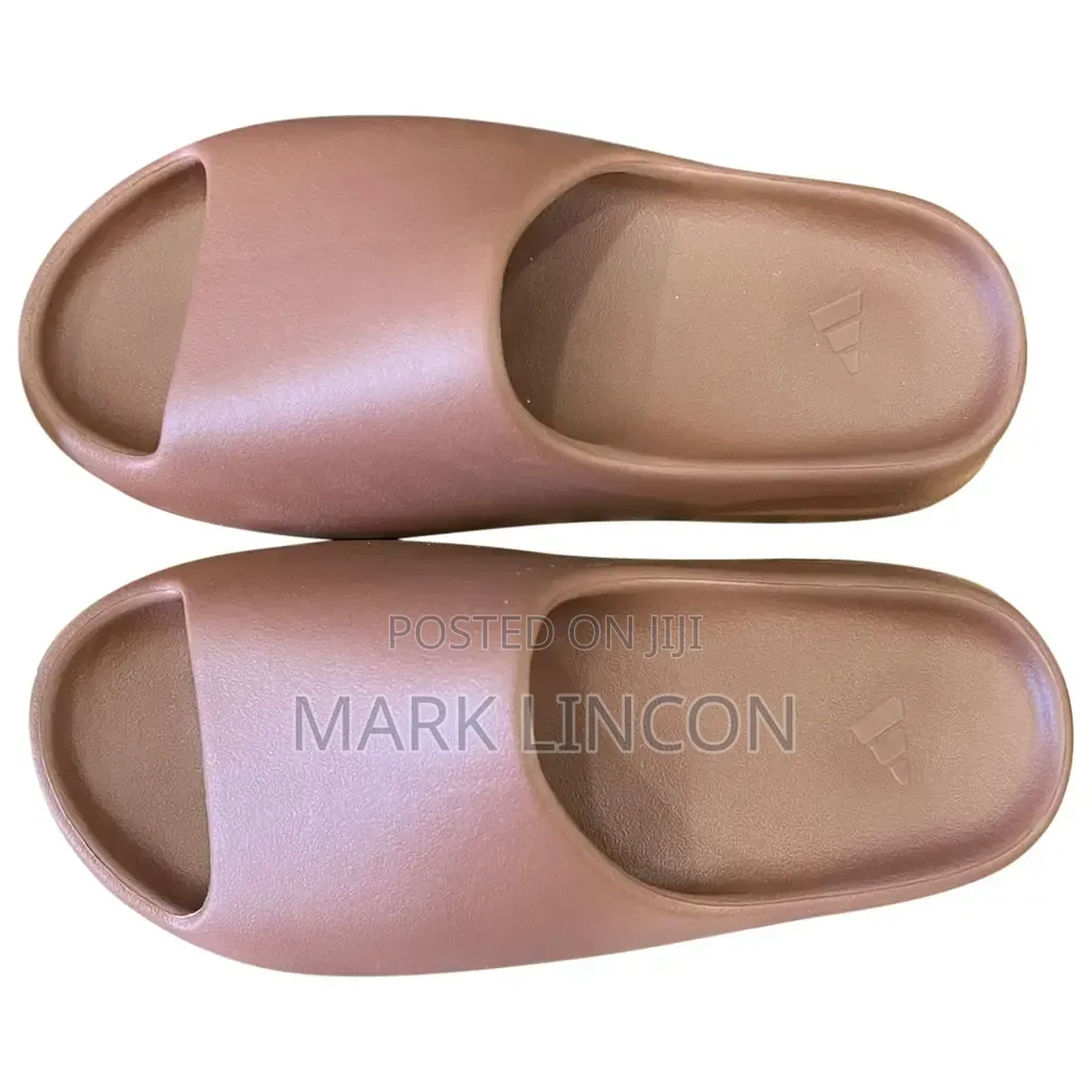 Adidas Yeezy Slides in a Dusty Rose or Ochre Colorway.