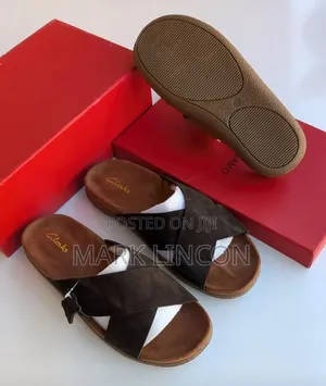 Clarks Men's Suede Slide Sandals Feature a Distinct Brown Cross-Strap
