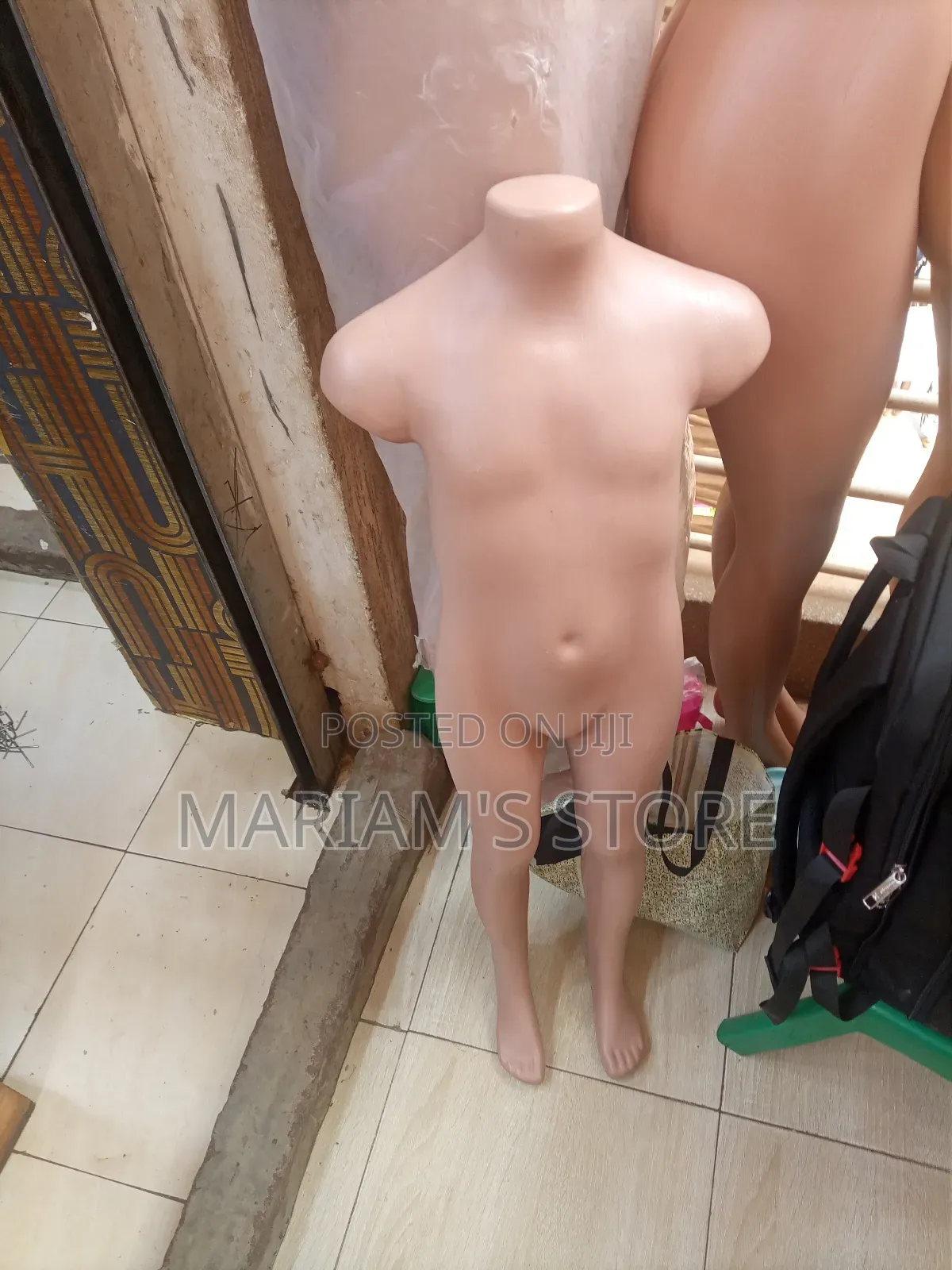 Plastic Dummy Is A Headless For Displaying Children's Clothing.