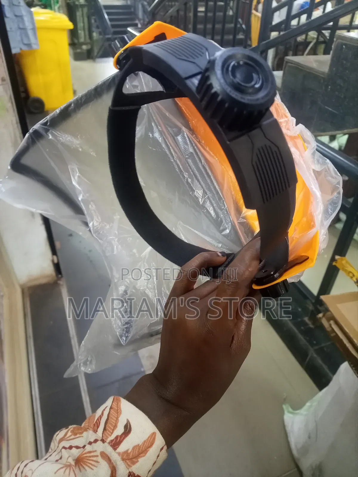 Safety Helmet With A Clear Plastic Brim And A Metal Mesh Visor.