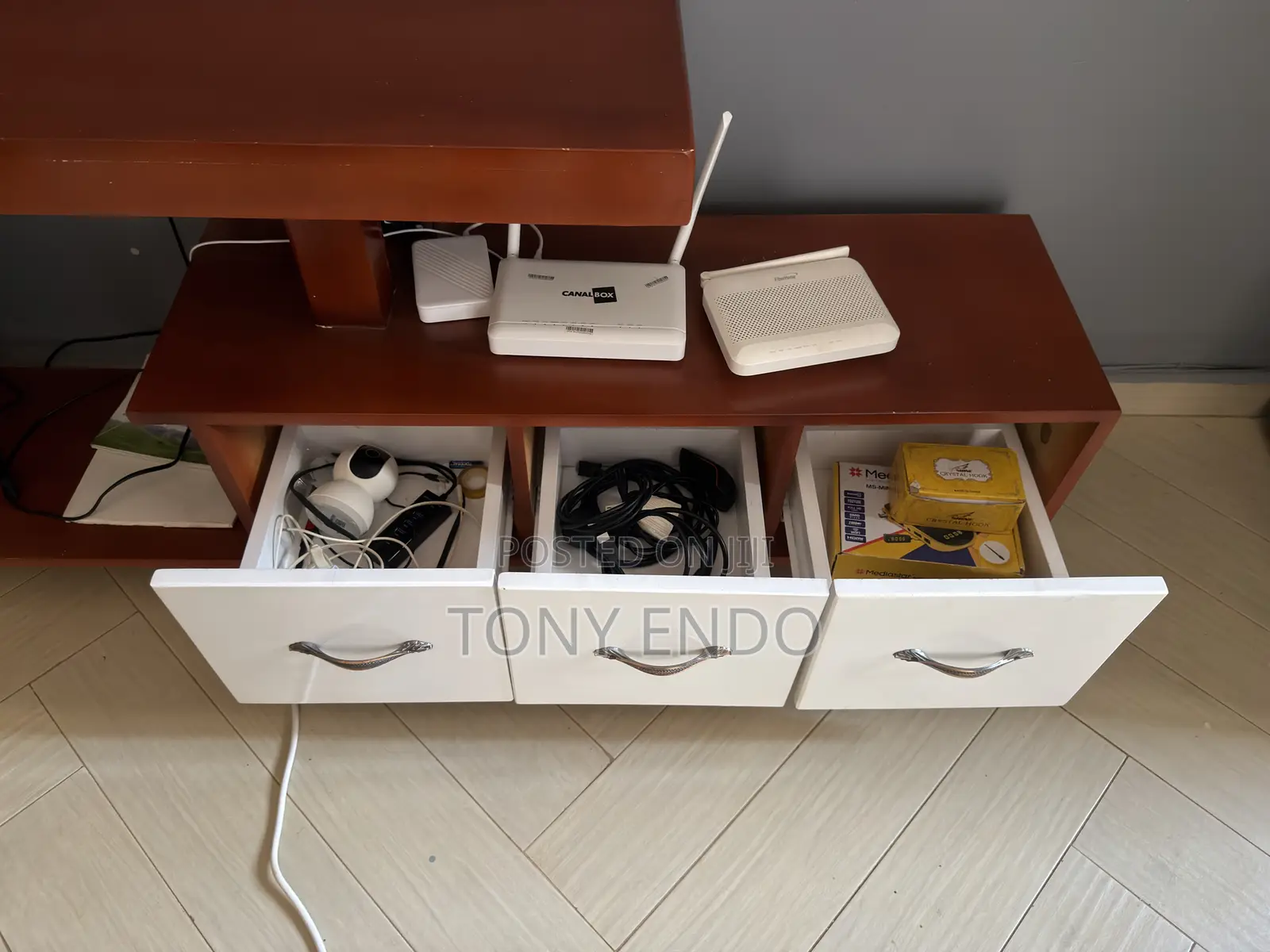 Tv Stand With a Modern Asymmetrical Design With White Drawer Fronts.