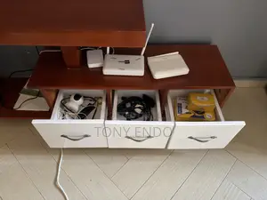 Tv Stand With a Modern Asymmetrical Design With White Drawer Fronts.