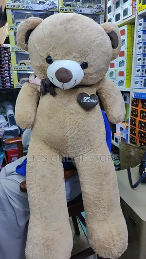 Brown Plush Teddy Bear Features a Decorative "Love" Heart Patch.