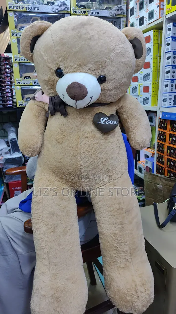 Brown Plush Teddy Bear Features a Decorative "Love" Heart Patch.
