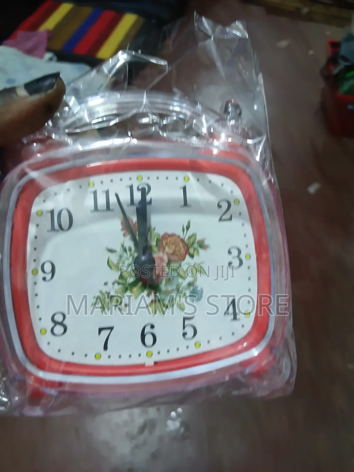 Red Alarm Clock Features a Vintage-Style Floral Design on Its Face.