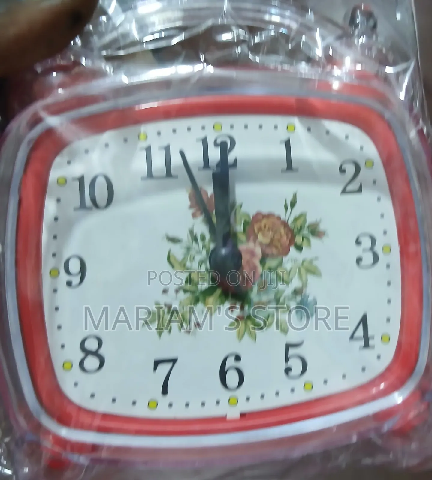 Red Alarm Clock Features a Vintage-Style Floral Design on Its Face.