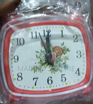 Red Alarm Clock Features a Vintage-Style Floral Design on Its Face.