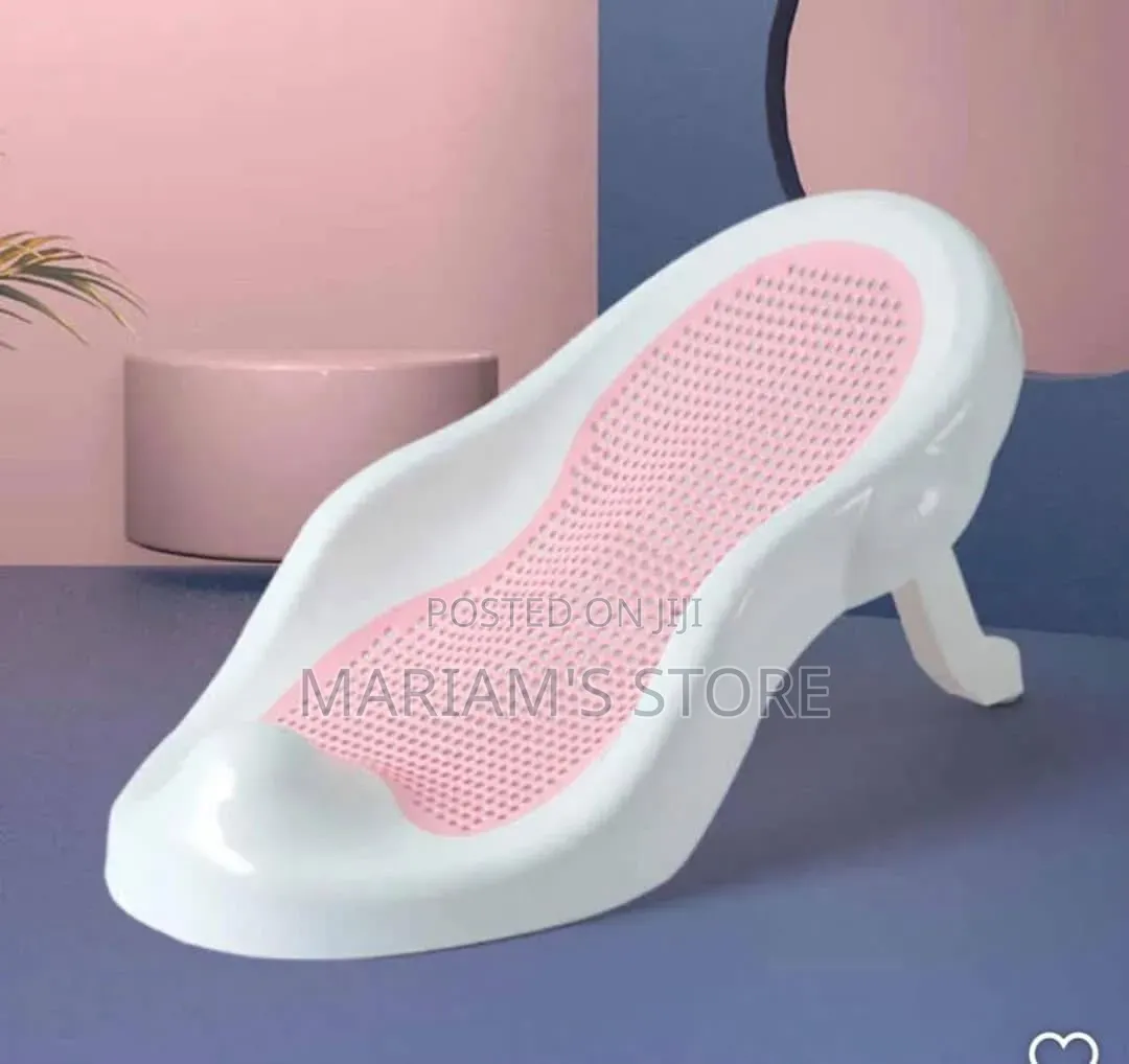Kid Baby Bather , a White Plastic Frame With a Pink Mesh Support Seat