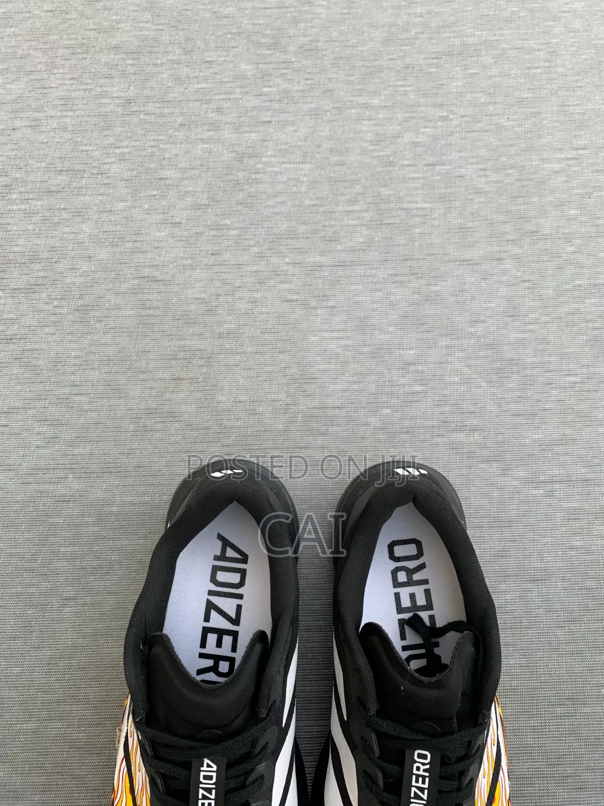 Adidas Adizero EvoBlack and White With a Flame Graphic Pattern