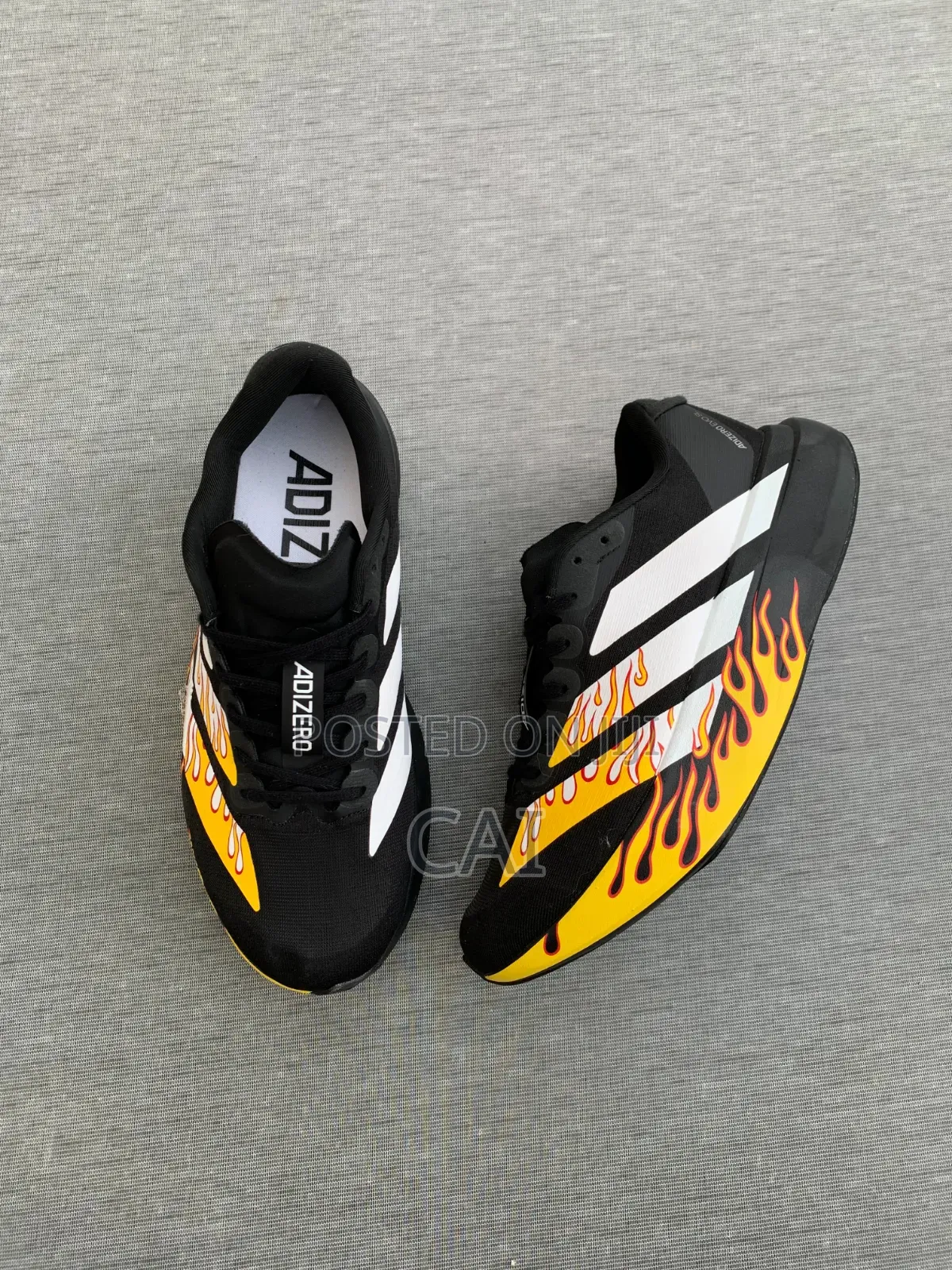 Adidas Adizero EvoBlack and White With a Flame Graphic Pattern