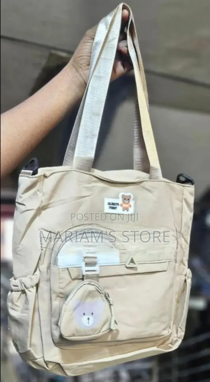 Beige Tote Bag Features a Small, Detachable Teddy Bear Pouch Charm