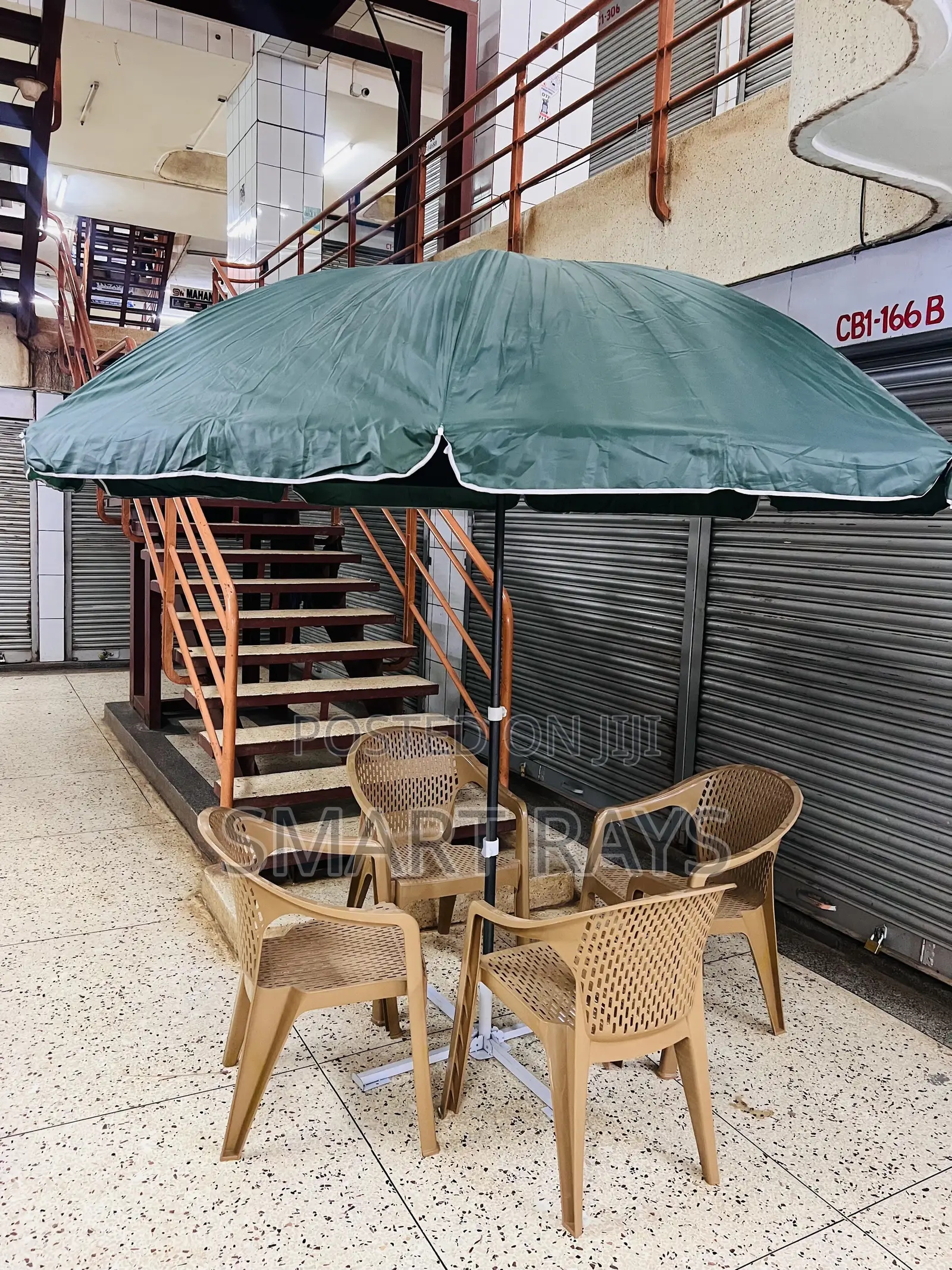 Round Patio Umbrella With a Stand and Four Chairs